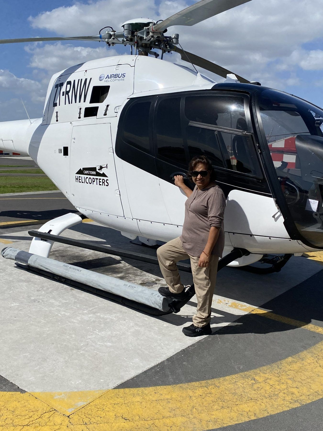 Dee beside the helicopter in Cape Town