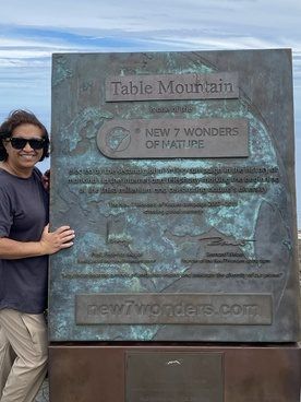 Dee beside the Table Mountain New 7 Wonders plaque